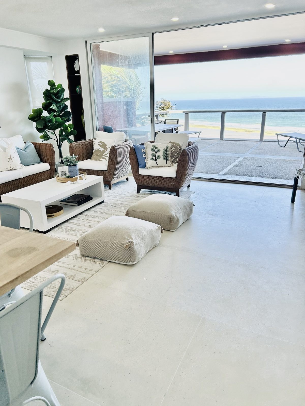 Oceanfront vacation rental living room opening onto a balcony with sea views