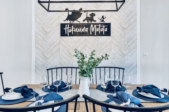 Dining area with whitewashed herringbone feature wall and navy table setting