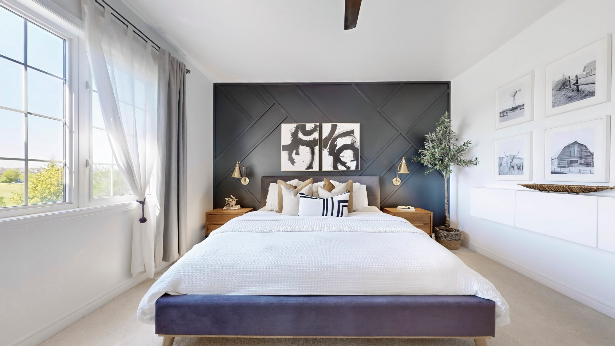Staged primary bedroom with navy feature wall — AS Interiors Canada